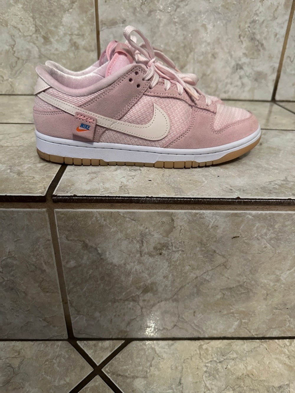 Nike Pink Low-Top Sneaker with Cream Swoosh and Gum Outsole